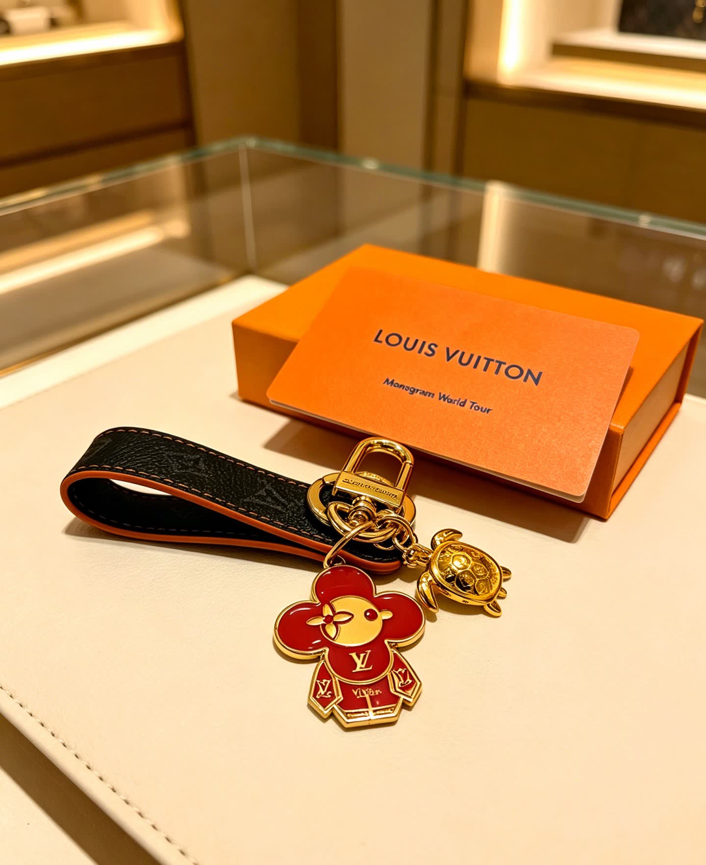 Louis Vuitton Leather Keychain with Flower and Turtle Charm